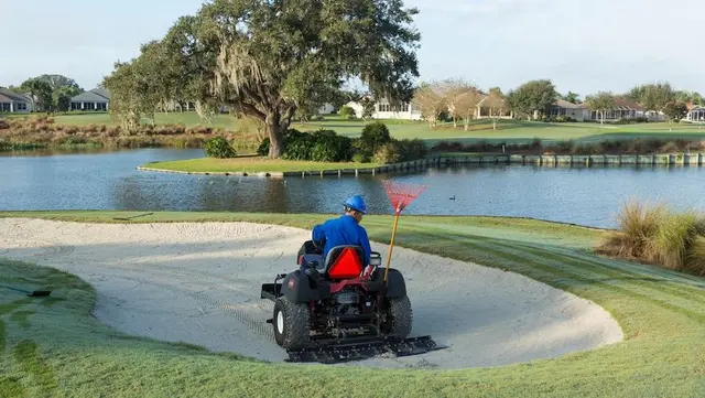 crew member operating bunker rake safely